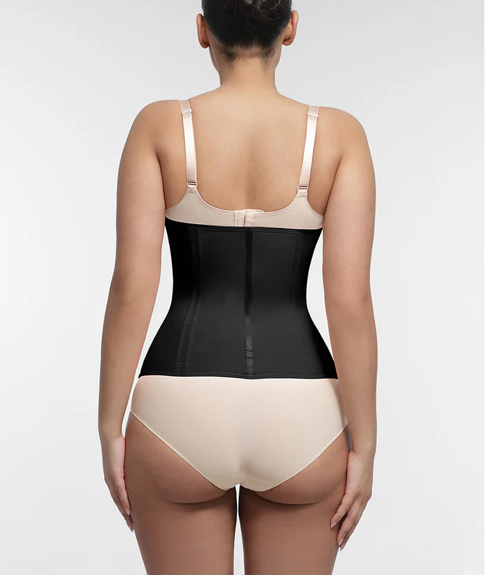 Woman wearing a black shapewear bodysuit on a white background
